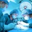 Masked veterinarians control infection by maintaining a sterile and clean environment during a procedure in a surgical suite.